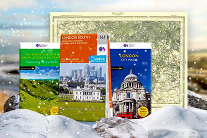 Picture of various OS Maps and guidebooks on a snow background
