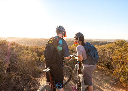 People with bicycle and map