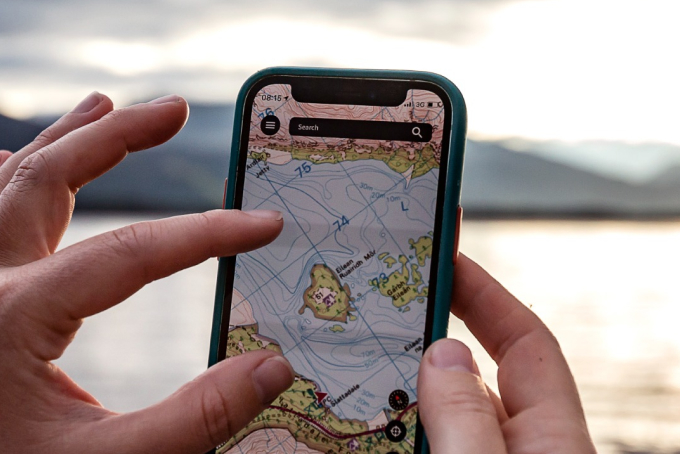 Man holding phone with OS Maps open